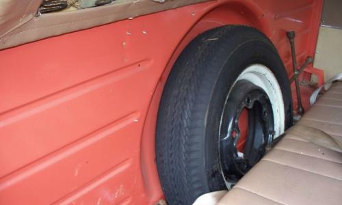 Spare wheel behind front seat in Volkswagen Deluxe Microbus.jpg
