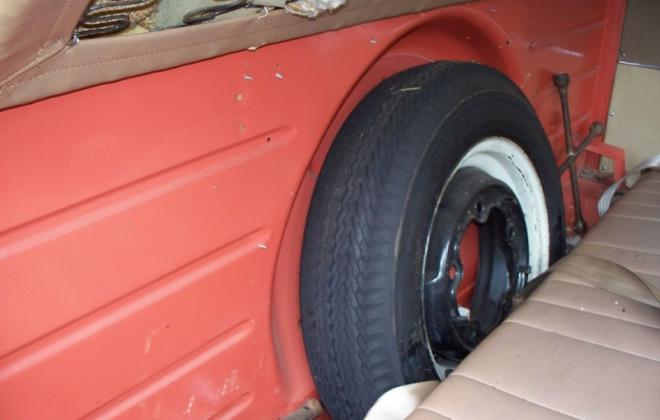 Spare wheel behind front seat in Volkswagen Deluxe Microbus.jpg